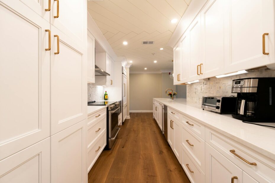 Bright modern kitchen with white cabinets, wooden floor, and appliances. (Photo by Lee Salem on Pexels)