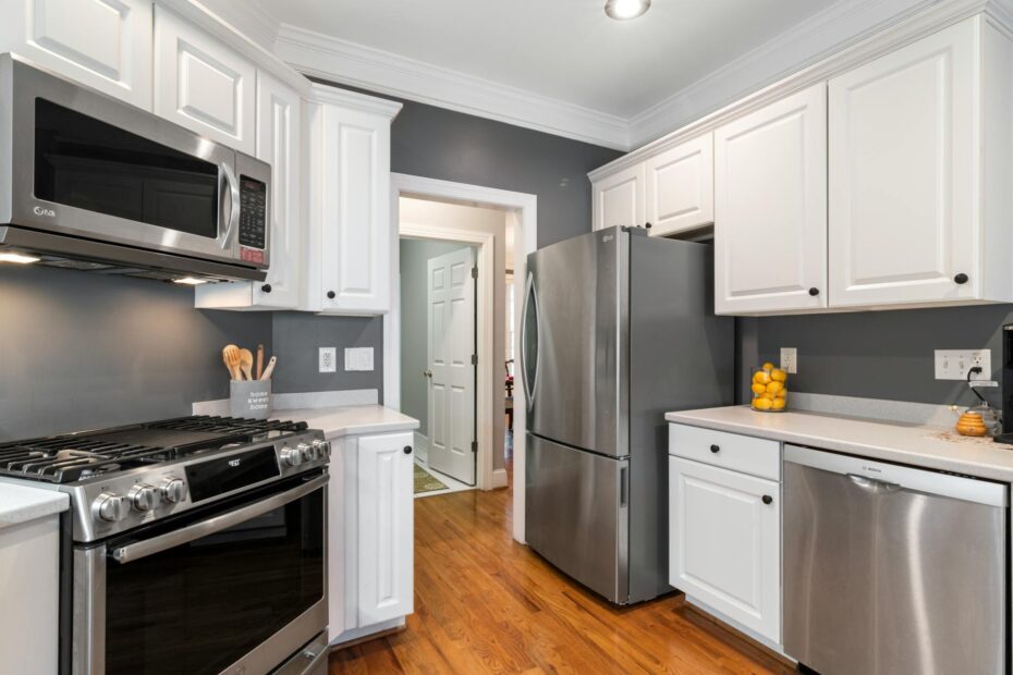 Contemporary kitchen with stainless steel appliances and white cabinets. (Photo by Curtis Adams on Pexels)