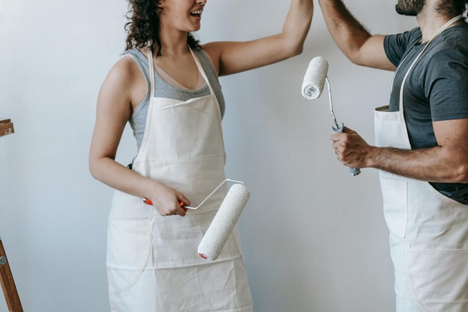 A joyful couple high-fiving during a home renovation project. Modern and casual lifestyle scene. (Photo by Blue Bird on Pexels)