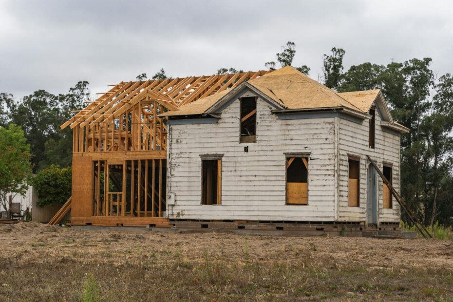 Image of an old house under renovation with new wooden frame structure. (Photo by Robert So on Pexels)