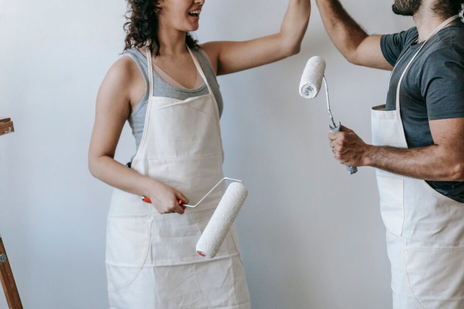 A joyful couple high-fiving during a home renovation project. Modern and casual lifestyle scene. (Photo by Blue Bird on Pexels)